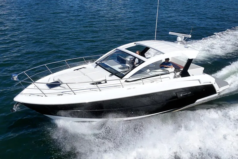 Slide: The Image of 2021 Cruisers Yachts 390 Express Coupe cruising on open water. - 10