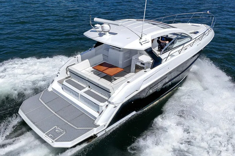 Slide: The Image of 2021 Cruisers Yachts 390 Express Coupe cruising on open water, rear view. - 12