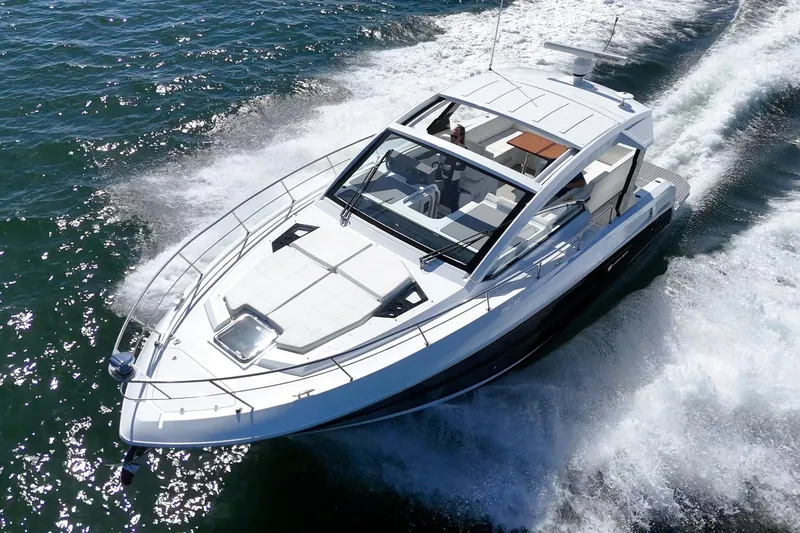 Slide: The Image of 2021 Cruisers Yachts 390 Express Coupe cruising on open water. - 13
