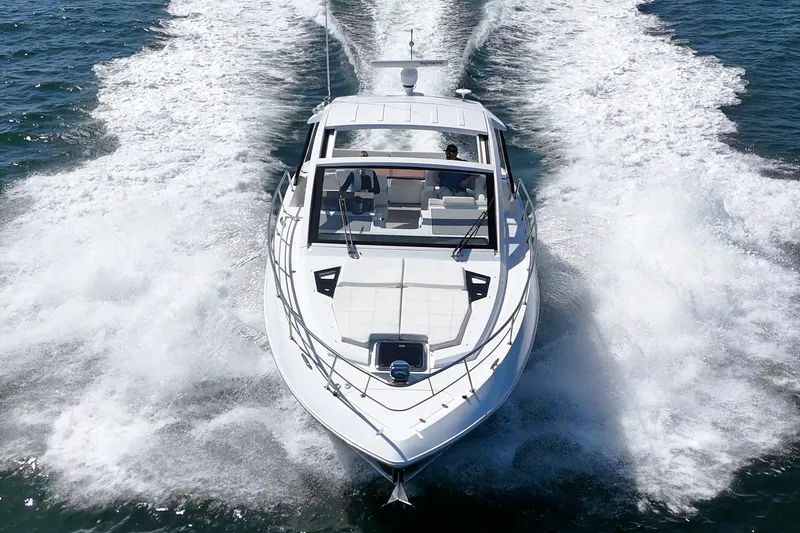 Slide: The Image of 2021 Cruisers Yachts 390 Express Coupe speeding on open water, aerial view. - 14