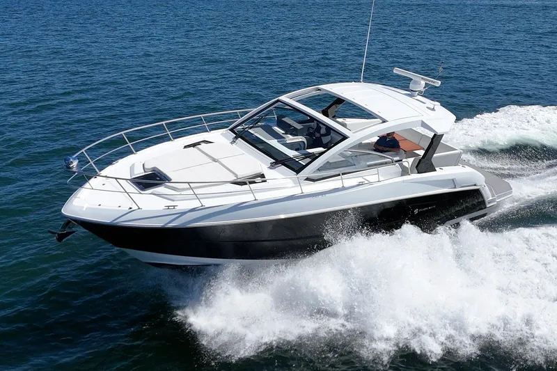 Slide: The Image of 2021 Cruisers Yachts 390 Express Coupe cruising on open water. - 16