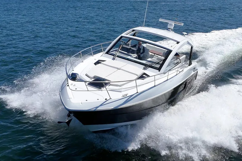 Slide: The Image of 2021 Cruisers Yachts 390 Express Coupe speeding on open water. - 17