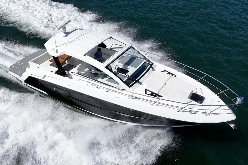 Slide: The Image of 2021 Cruisers Yachts 390 Express Coupe cruising on open water. - 24