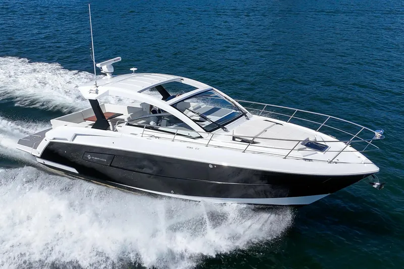 Slide: The Image of 2021 Cruisers Yachts 390 Express Coupe cruising on open water. - 25