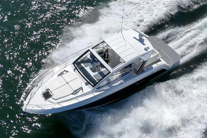 Slide: The Image of 2021 Cruisers Yachts 390 Express Coupe speeding on water, aerial view. - 27