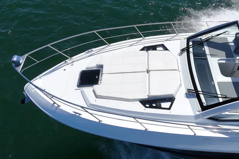 Slide: The Image of 2021 Cruisers Yachts 390 Express Coupe on water, featuring sleek design and spacious deck. - 33