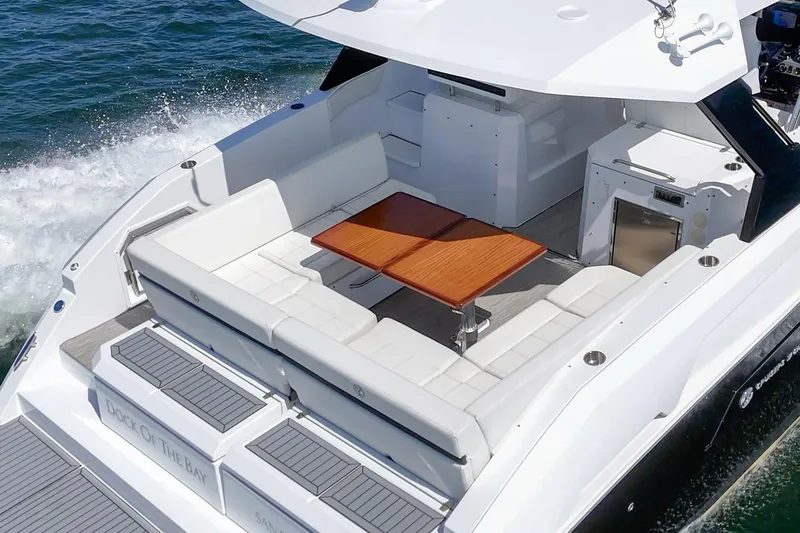 Slide: The Image of 2021 Cruisers Yachts 390 Express Coupe with spacious deck and seating area on the water. - 35