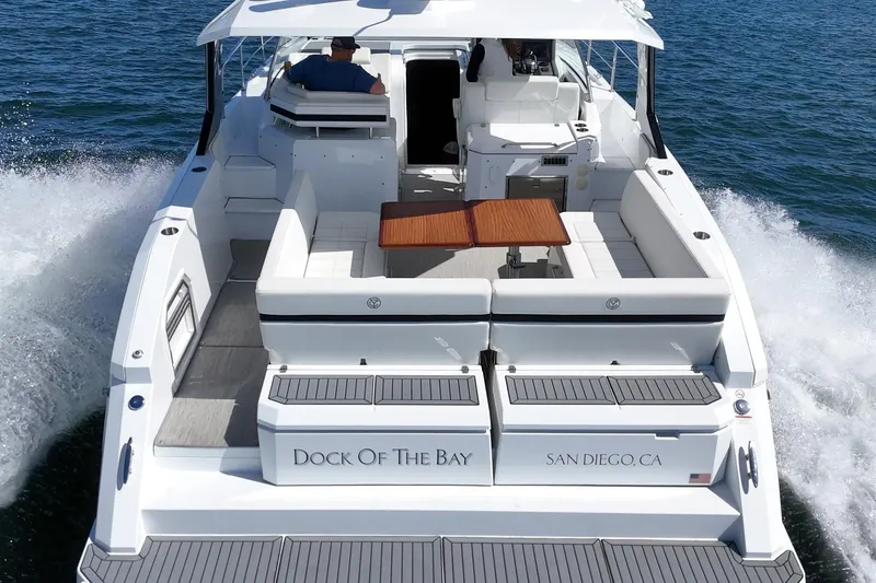 Slide: The Image of 2021 Cruisers Yachts 390 Express Coupe cruising on open water, rear view. - 36