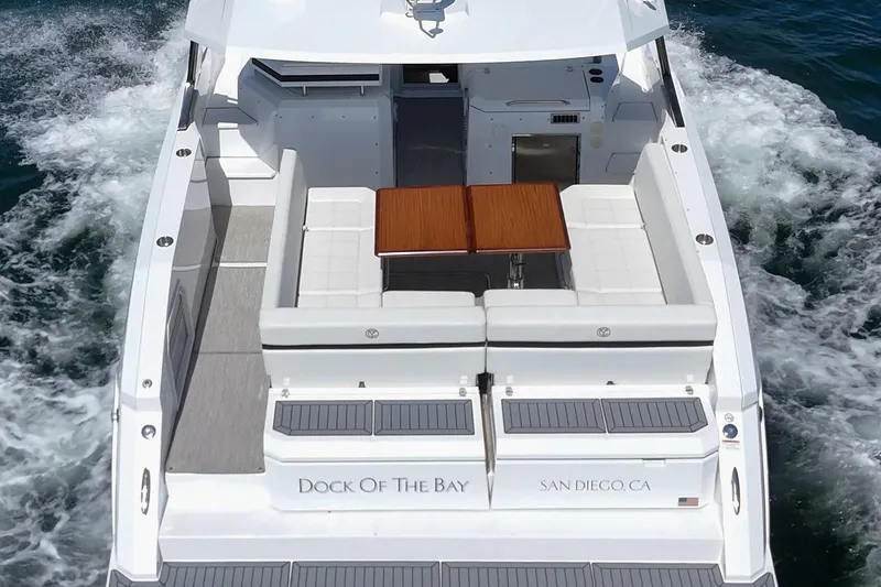 Slide: The Image of 2021 Cruisers Yachts 390 Express Coupe cruising, rear view, with seating and table. - 37