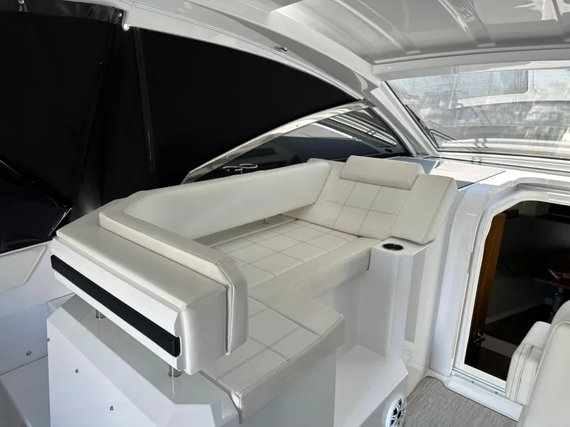 Slide: The Image of 2021 Cruisers Yachts 390 Express Coupe interior with white seating and modern design. - 43