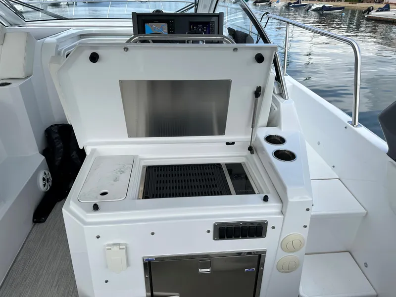 Slide: The Image of 2021 Cruisers Yachts 390 Express Coupe outdoor kitchen with grill and storage. - 44