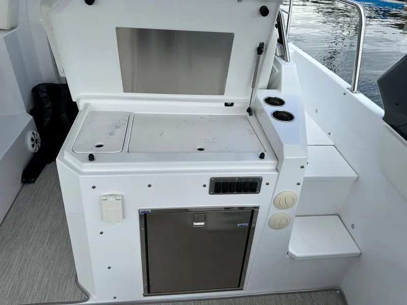 Slide: The Image of 2021 Cruisers Yachts 390 Express Coupe outdoor kitchenette with storage and cup holders. - 45