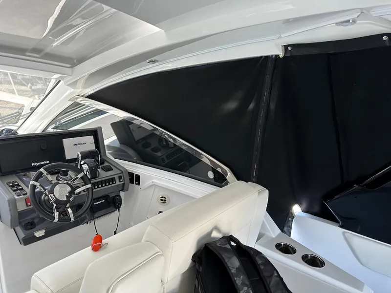 Slide: The Image of 2021 Cruisers Yachts 390 Express Coupe cockpit with steering wheel and navigation system. - 47