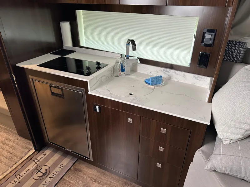 Slide: The Image of Modern kitchen area in 2021 Cruisers Yachts 390 Express Coupe with sleek appliances. - 49