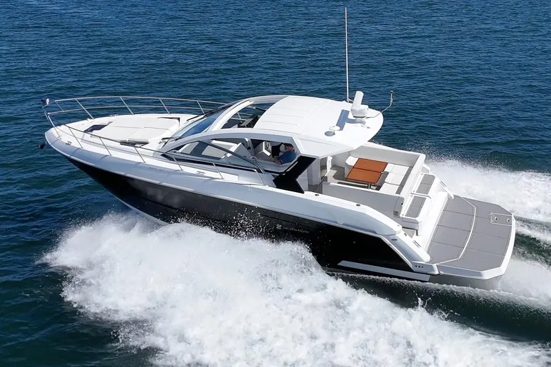 Slide: The Image of 2021 Cruisers Yachts 390 Express Coupe cruising on open water, showcasing sleek design and luxury. - 5