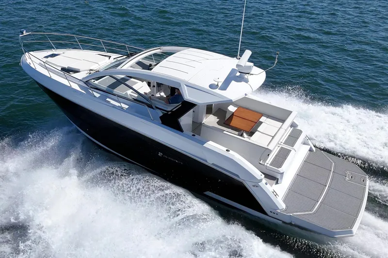 Slide: The Image of 2021 Cruisers Yachts 390 Express Coupe cruising on open water. - 6