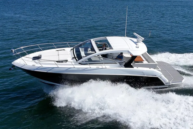 Slide: The Image of 2021 Cruisers Yachts 390 Express Coupe cruising on open water. - 8