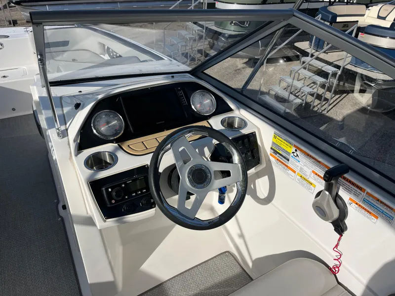 Slide: The Image of 2020 Hurricane SunDeck 235 OB boat dashboard with steering wheel and controls. - 10
