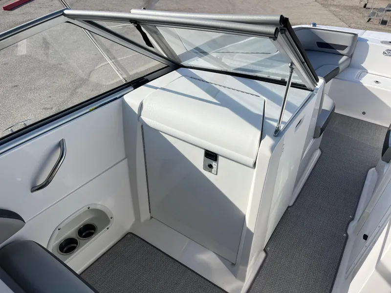 Slide: The Image of 2020 Hurricane SunDeck 235 OB interior with seating and storage, featuring sleek design and modern amenities. - 11