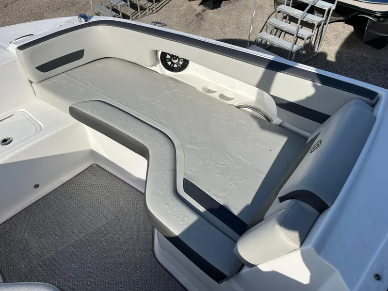 Slide: The Image of 2020 Hurricane SunDeck 235 OB boat interior with cushioned seating and speaker. - 14