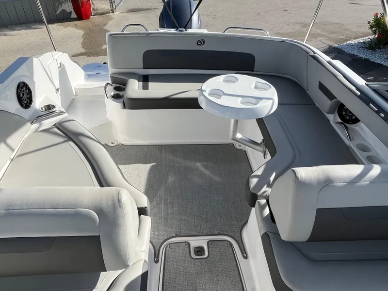 Slide: The Image of 2020 Hurricane SunDeck 235 OB interior with seating and table, showcasing spacious design. - 17
