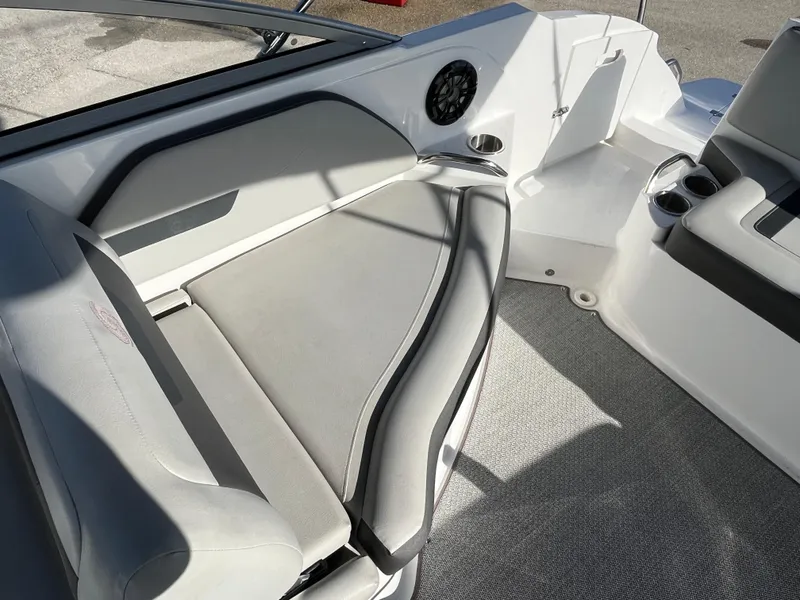 Slide: The Image of 2020 Hurricane SunDeck 235 OB boat interior with cushioned seating and speaker. - 18
