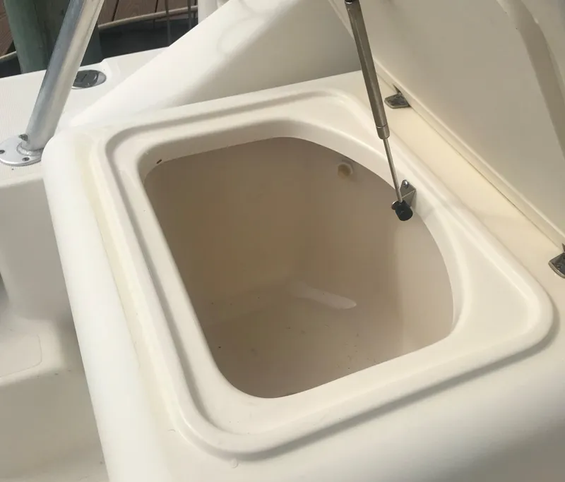 Slide: The Image of Open storage compartment on a 2002 Pursuit 3000 Express boat. - 10