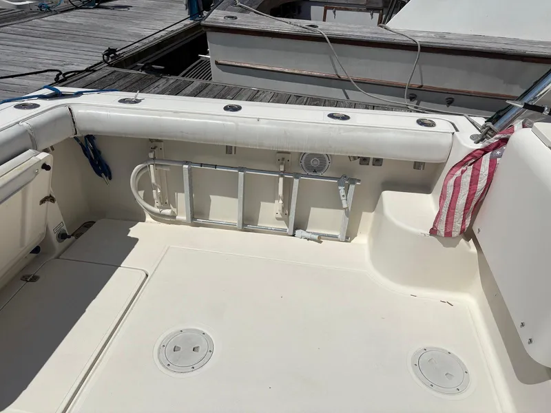 Slide: The Image of 2002 Pursuit 3000 Express boat deck with ladder and storage compartments. - 14