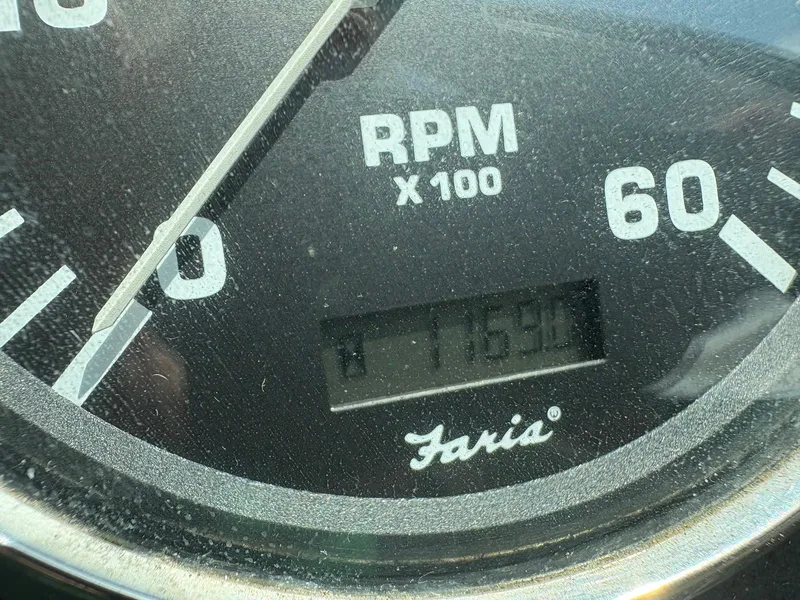 Slide: The Image of Close-up of a Faria RPM gauge showing 1759 hours on a 2002 Pursuit 3000 Express. - 17