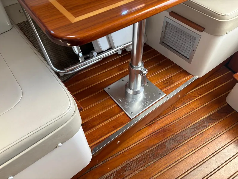 Slide: The Image of Interior of 2002 Pursuit 3000 Express boat with wooden flooring and seating area. - 19