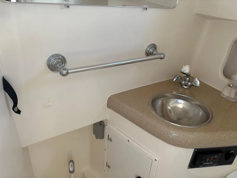 Slide: The Image of 2002 Pursuit 3000 Express boat bathroom with sink and countertop. - 23