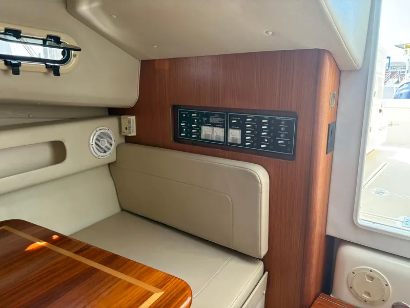 Slide: The Image of Interior of 2002 Pursuit 3000 Express boat with control panel and seating area. - 28