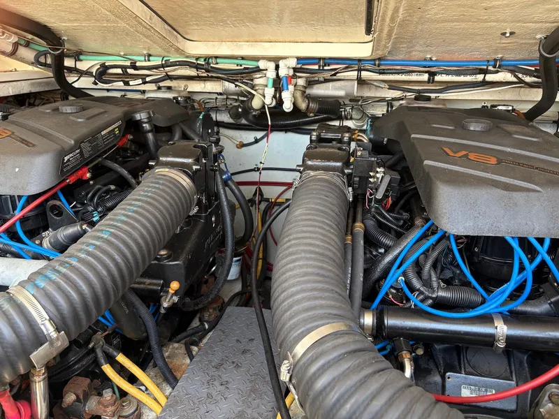Slide: The Image of Engine compartment of a 2002 Pursuit 3000 Express boat, featuring dual V8 engines. - 29