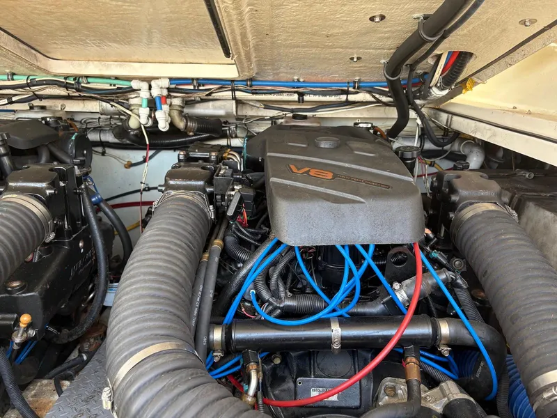 Slide: The Image of Engine compartment of a 2002 Pursuit 3000 Express boat, featuring a V8 engine. - 30