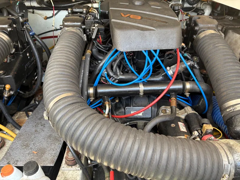 Slide: The Image of Engine compartment of a 2002 Pursuit 3000 Express boat with visible V8 engine components. - 31