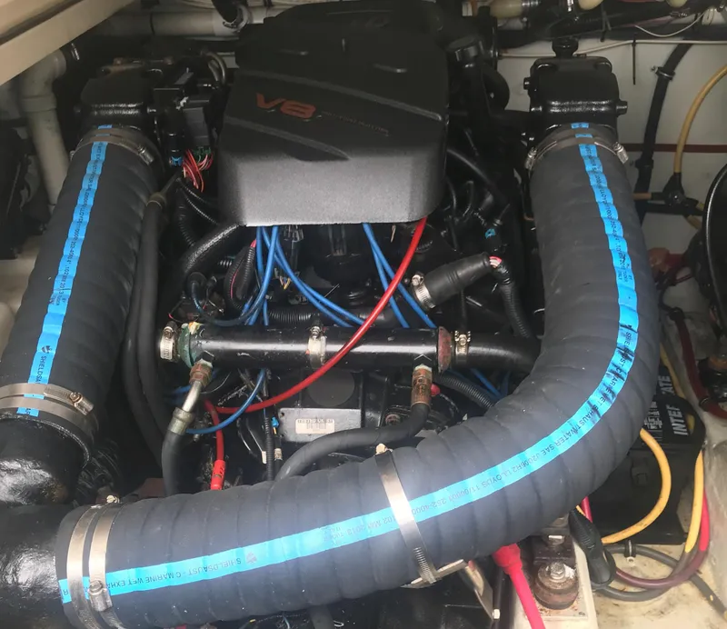 Slide: The Image of Engine compartment of a 2002 Pursuit 3000 Express boat with visible V8 engine components. - 32