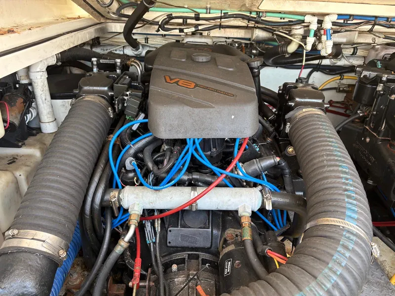 Slide: The Image of Engine compartment of a 2002 Pursuit 3000 Express boat with V8 engine and wiring. - 33