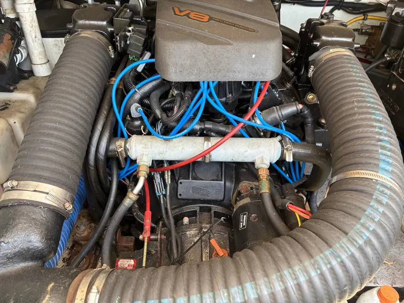 Slide: The Image of Engine of a 2002 Pursuit 3000 Express boat with visible V8 components. - 34