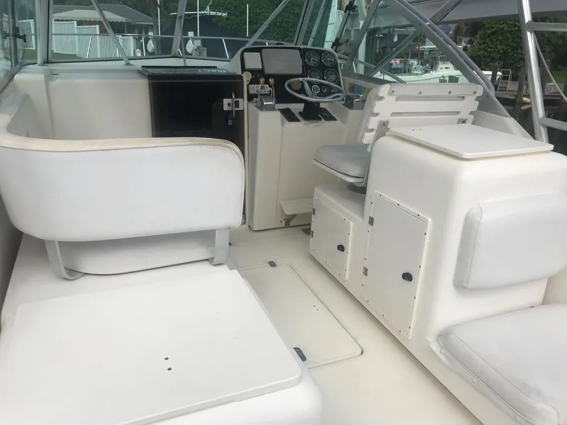 Slide: The Image of 2002 Pursuit 3000 Express boat interior with white seating and control panel. - 5