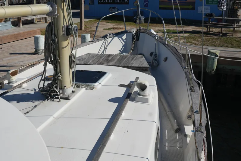 Slide: The Image of 1977 Fisher 37 MS sailboat deck with mast and rigging in a marina setting. - 10