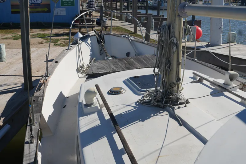 Slide: The Image of 1977 Fisher 37 MS sailboat docked, showcasing deck and rigging details. - 11