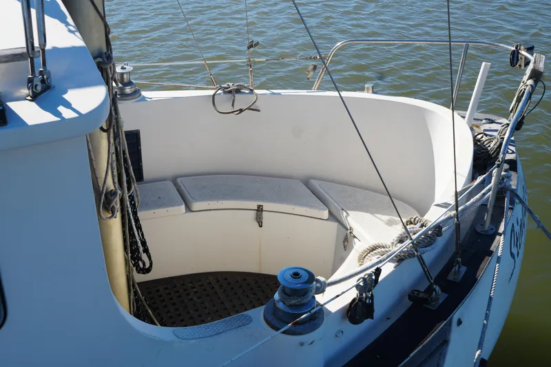 Slide: The Image of 1977 Fisher 37 MS sailboat cockpit with seating, ropes, and winch on calm water. - 13