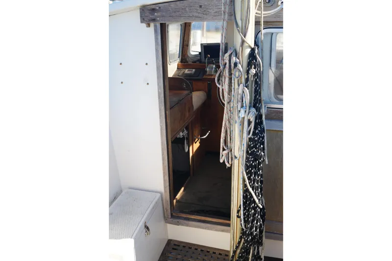 Slide: The Image of Interior view of a 1977 Fisher 37 MS sailboat with ropes and wooden details. - 14