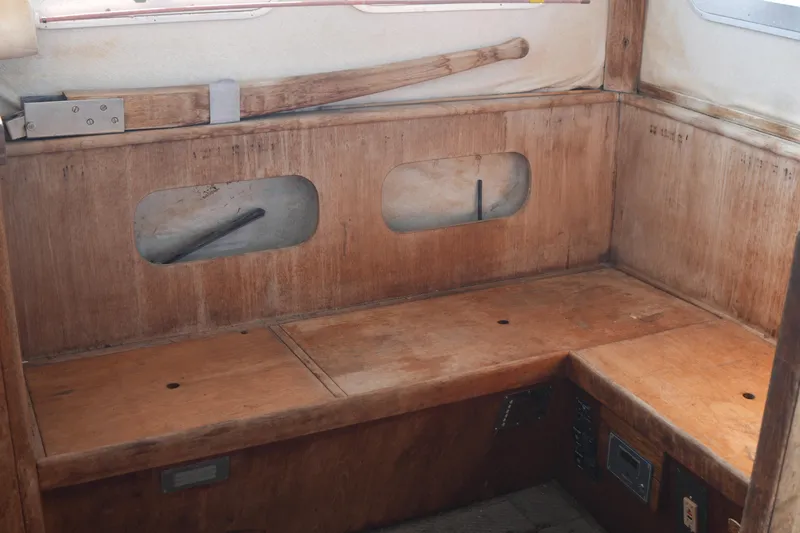 Slide: The Image of 1977 Fisher 37 MS boat interior with wooden seating and storage compartments. - 19