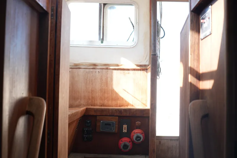 Slide: The Image of Interior of 1977 Fisher 37 MS boat with wooden paneling and control switches. - 20