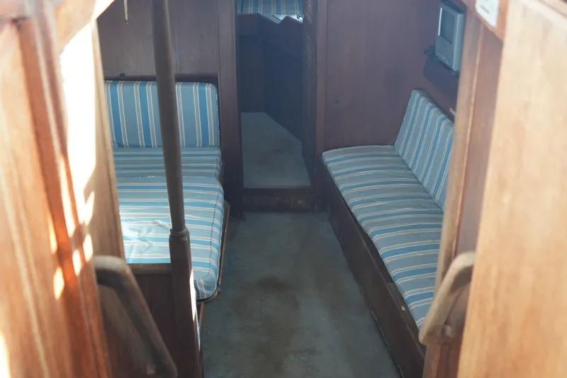 Slide: The Image of Interior of 1977 Fisher 37 MS boat with striped seating and wooden paneling. - 21