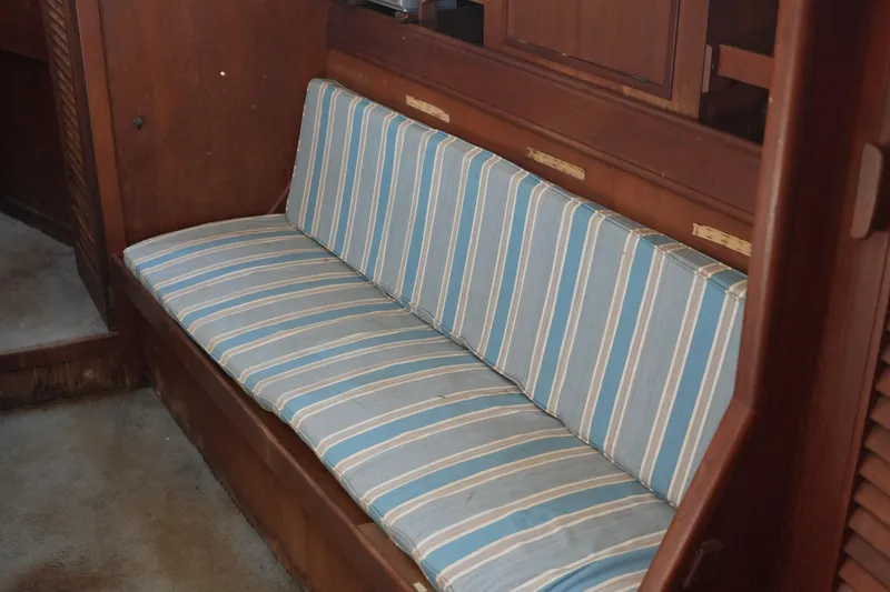 Slide: The Image of Interior of 1977 Fisher 37 MS with striped blue cushioned seating. - 27
