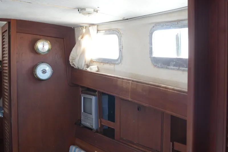 Slide: The Image of Interior of 1977 Fisher 37 MS boat with wooden paneling and nautical instruments. - 28