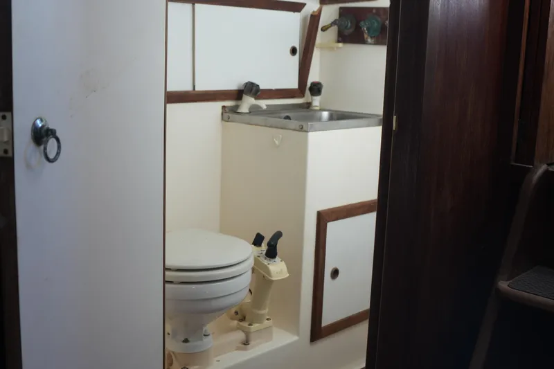 Slide: The Image of 1977 Fisher 37 MS yacht bathroom with toilet and sink. - 29