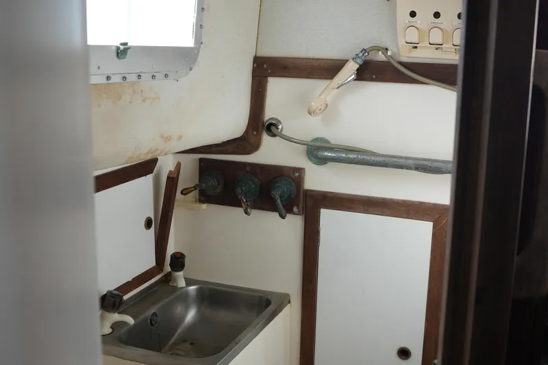 Slide: The Image of 1977 Fisher 37 MS boat interior with sink and shower fixtures. - 30